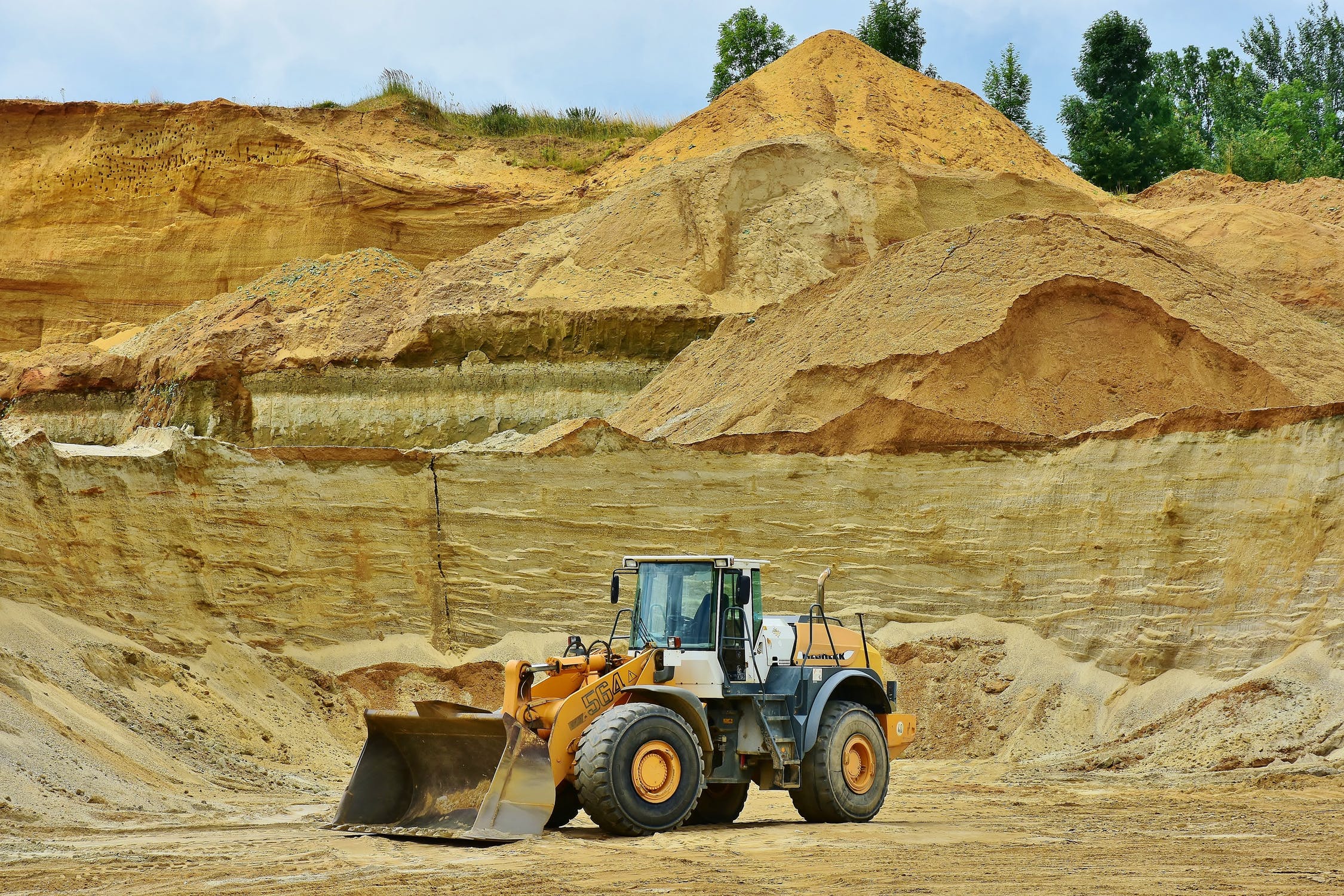 Heavy equipment moving fill material during grading and excavation work